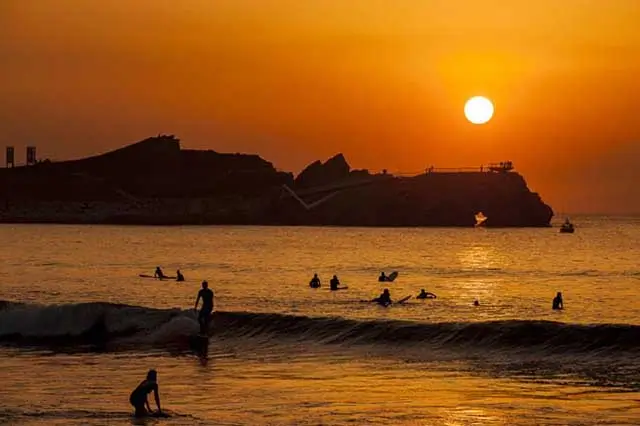 Expansive Salinas Beach, popular for summer camp activities in Asturias.