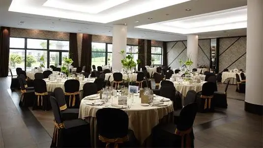 Spacious dining hall in the 4-star hotel for summer camp participants and coaches.