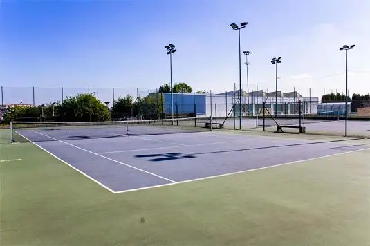 Outdoor tennis court at the summer camp's sports campus in Northern Spain.